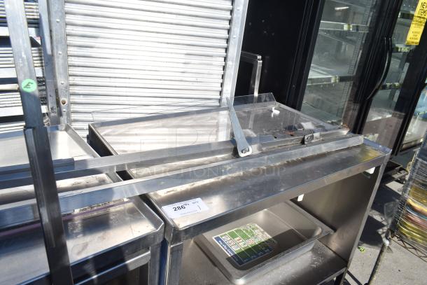 Commercial portable counter with under-shelf and drawer, on casters. Stainless steel, includes ID tag "#286", used condition.