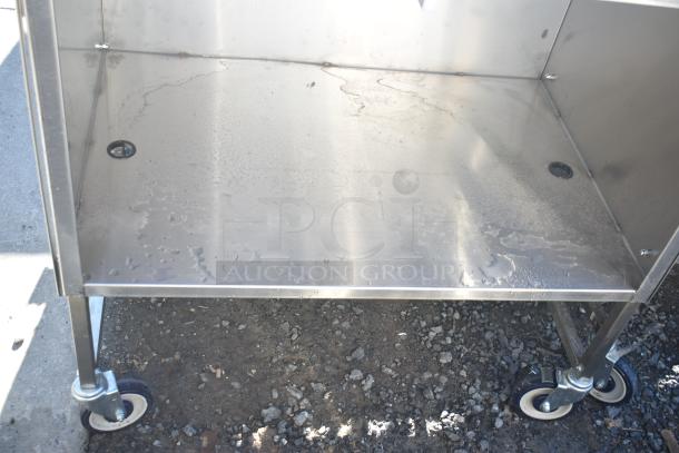 National Cart portable counter with under shelf, drawer, and commercial casters, stainless steel, good condition.