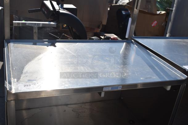 National Cart commercial portable counter with under shelf, drawer, and commercial casters. Features stainless steel top with visible labels.