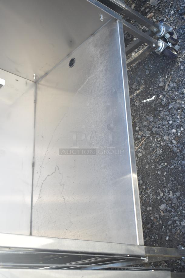 National Cart commercial portable counter features an under-shelf, drawer, and commercial casters. Constructed in durable metal.