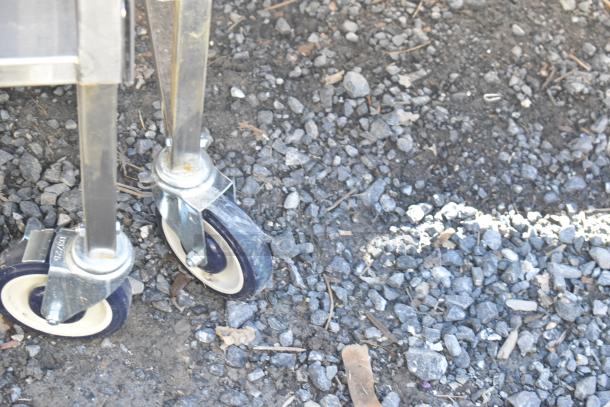 National Cart portable counter with under shelf and drawer, mounted on durable commercial casters; sturdy and mobile.