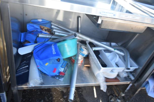 National Cart commercial portable counter with under shelf and drawer, on commercial casters. Includes assorted contents.