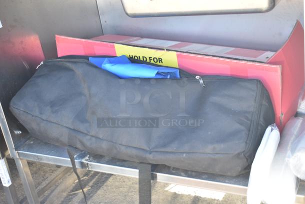 National Cart portable counter with contents, under shelf, drawer on commercial casters. Includes labeled box and black bag.