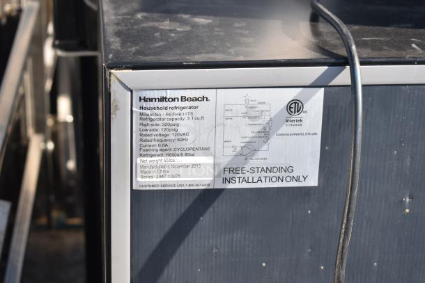Hamilton Beach mini cooler REFBHB31TS, 3.1 cu ft, 120VAC, label details including model, capacity, and installation info.
