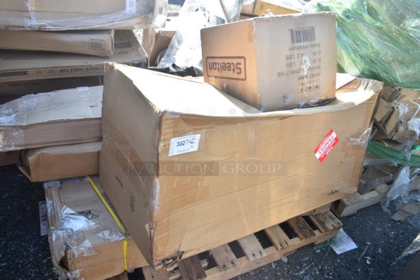 Cardboard boxes on pallet, labeled "Scratch and Dent." Items include cushions, shelf, work table; damaged packaging.