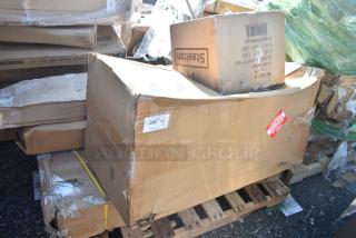 Cardboard boxes on pallet, labeled "Scratch and Dent." Items include cushions, shelf, work table; damaged packaging.
