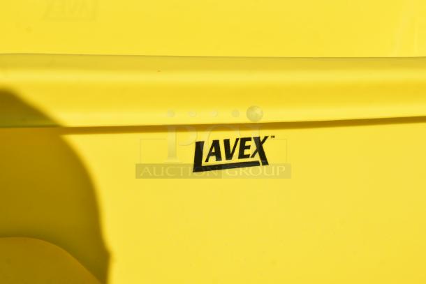 Lavex yellow tilt truck, brand new with minor scratches and dents. Prominent Lavex logo on the yellow surface.