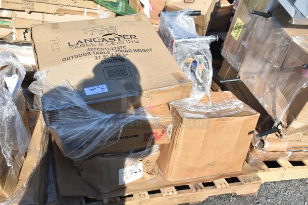 Boxes of 6 new scratch and dent items, including Lancaster outdoor table and towel dispenser, on pallet.