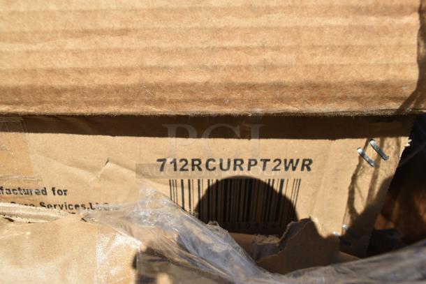 Cardboard box with printed code "712RCURPT2WR" and visible staples, indicating scratch and dent new items inside.