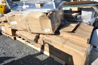 Damaged boxes of new Lancaster 2" padded seat black vinyl folding chairs on pallets; visible dents and tears.