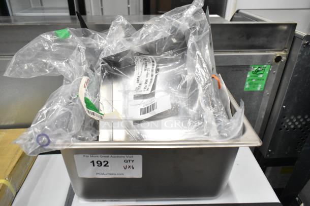 Six brand new scratch and dent items, including a condenser drain pan, door handle, bracket, and brush hanger, labeled with auction tag 192.