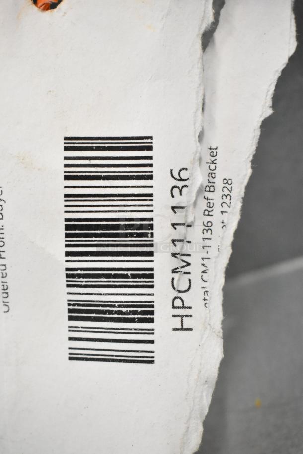 Barcode tag showing HPCM11136 label for reference bracket, part of scratch and dent auction items.