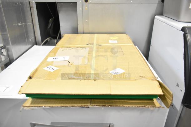 New scratch and dent Choice green polyethylene cutting board, 24"x18"x0.5", boxed with visible surface wear.