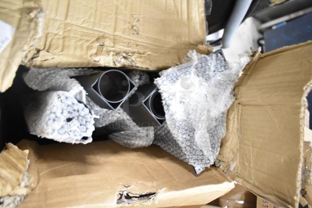 Box of Vulcan Wolf 424171-1 convection oven legs, new condition, with visible dents on packaging, wrapped in bubble wrap.