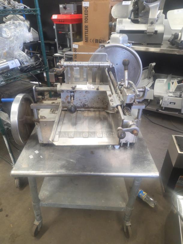 US Berkel commercial countertop flywheel meat slicer on equipment stand, fair condition, missing power cord.