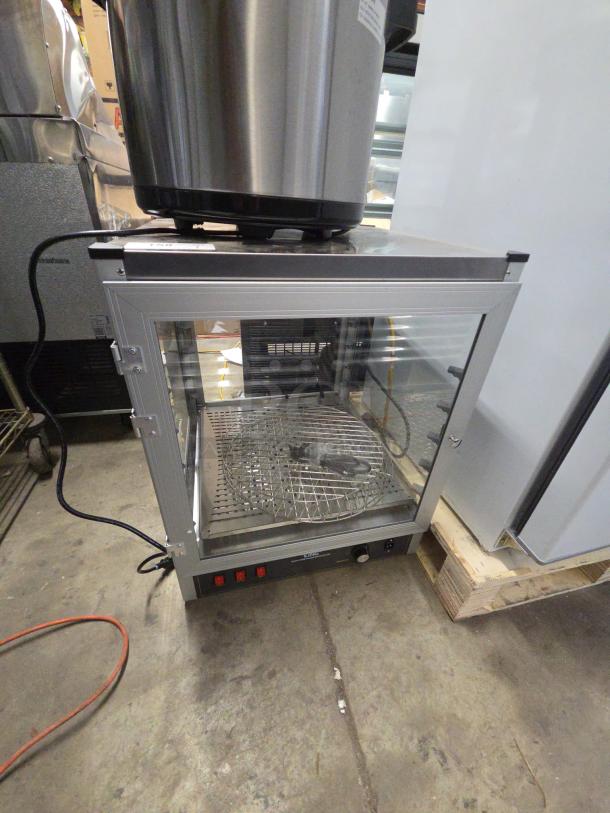 Brand new Carnival King 382HPWR18D2 18" pizza display warmer, tested and working, 120V, 1 phase, visible controls, minor dents.