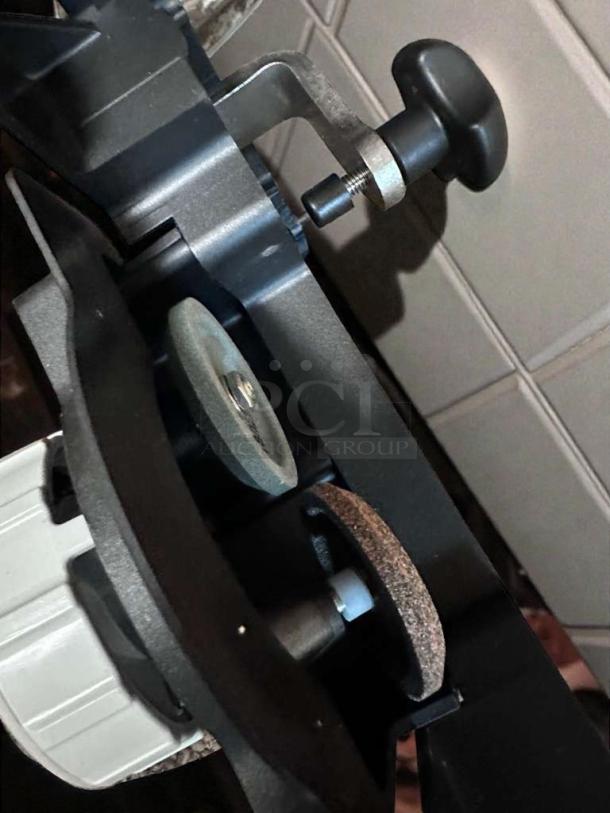 Bizerba GSP HD P-21 commercial deli slicer mechanism, black knob, and sharpening stone featured; fully operational.