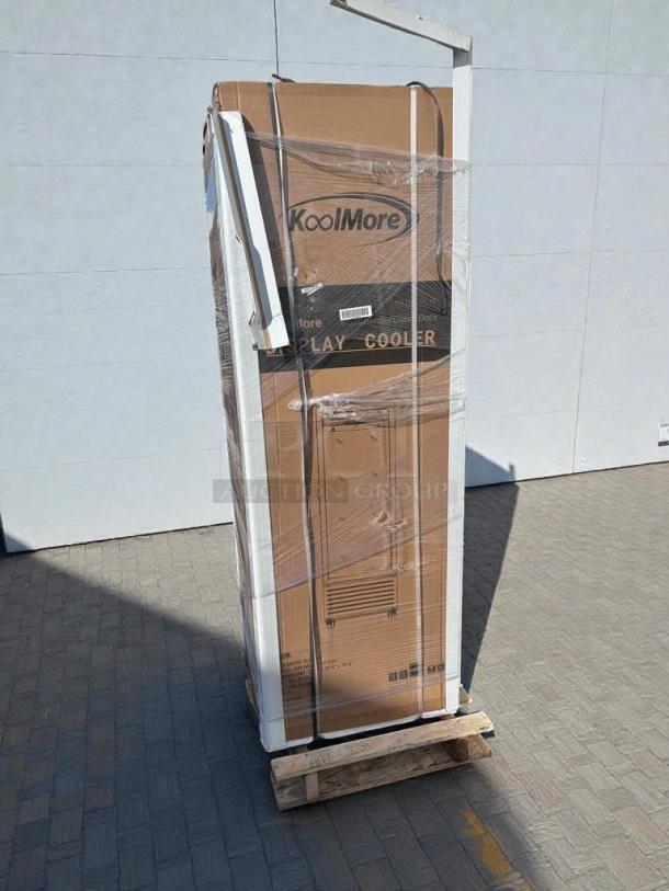 Brand new KoolMore MDR1GD12C commercial display refrigerator in packaging, labeled "Display Cooler," minor scratches and dents.