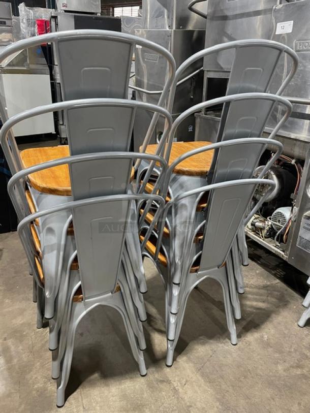 Set of Astor Series silver dining chairs with wood seats, like new condition, suitable for indoor/outdoor use. 