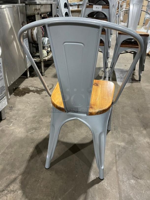 Astor Series silver dining chair, welded metal frame, wooden seat, like new condition, suitable for indoor/outdoor use.