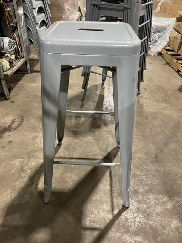 Like new Astor welded bar height silver dining chair, sturdy metal frame, sleek design, excellent condition.