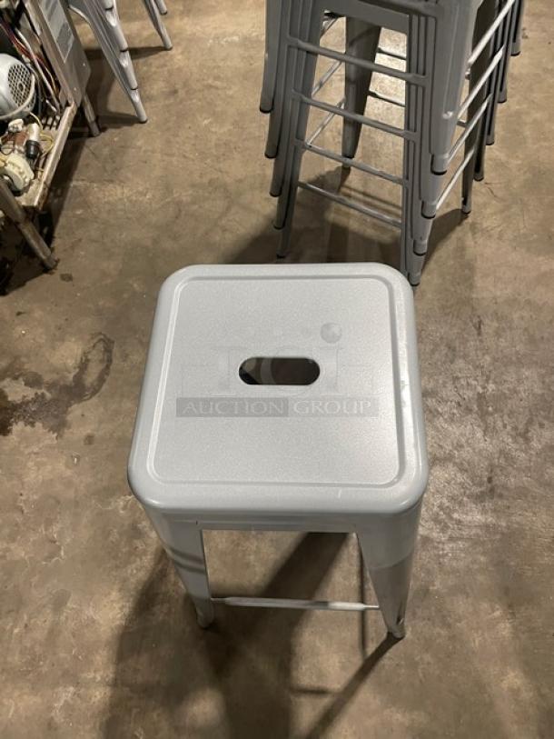 Astor welded bar height silver dining chairs, like new condition, set of 6, stackable design with a central cut-out handle.