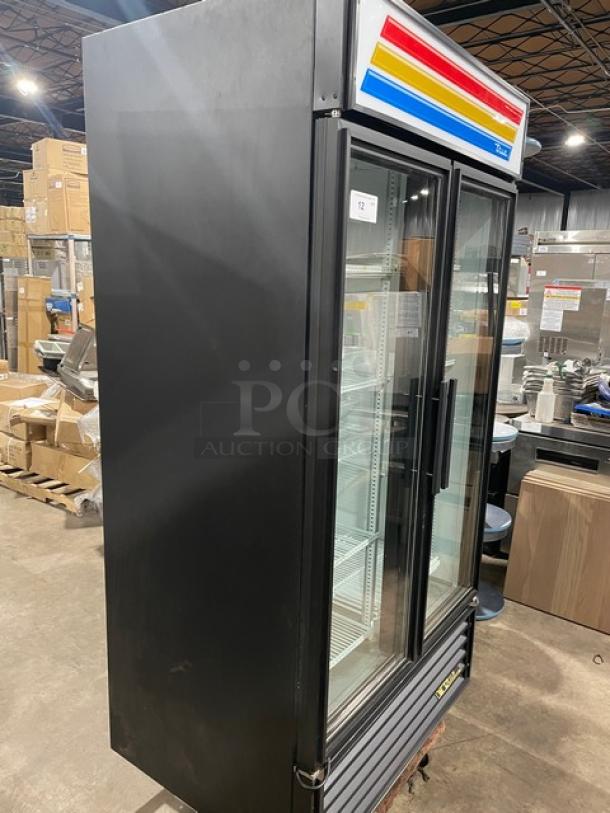 True 2 Door Reach-In Cooler Merchandiser, Model GDM35LD. Black exterior, glass doors, shelving inside, excellent condition.