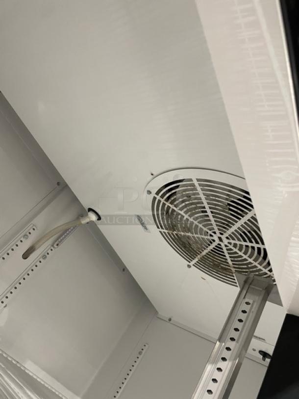 True GDM35LD 2-door reach-in cooler merchandiser, interior view showing fan and shelving. Serial #8466398, late model.