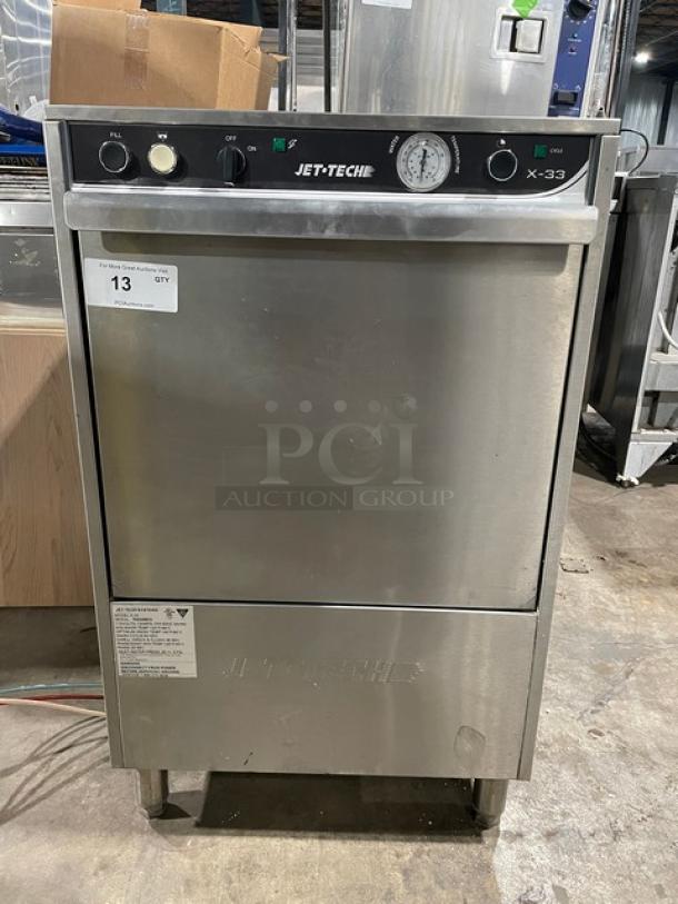 Jet Tech X-33 undercounter stainless steel dishwasher with rack, model X-33, serial 152048874, 115V, 1 Phase, on legs.