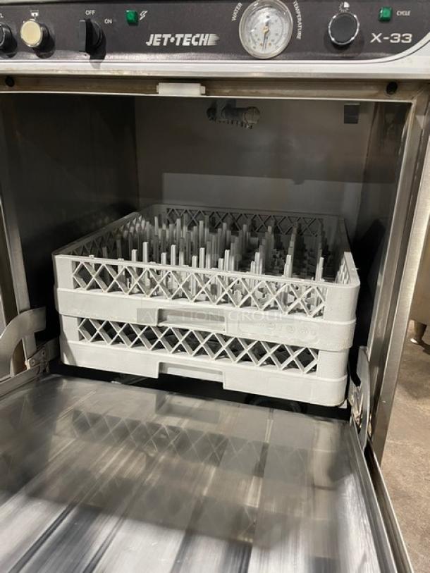 Jet Tech X-33 under-counter stainless steel dishwasher with rack, model X-33, serial 152048874, 115V 1Phase, on legs.