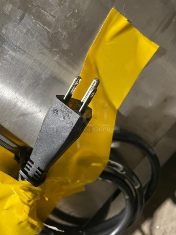 Jet Tech X-33 stainless steel dishwasher power cord with 115V plug, wrapped in yellow tape. Model and serial markings visible.