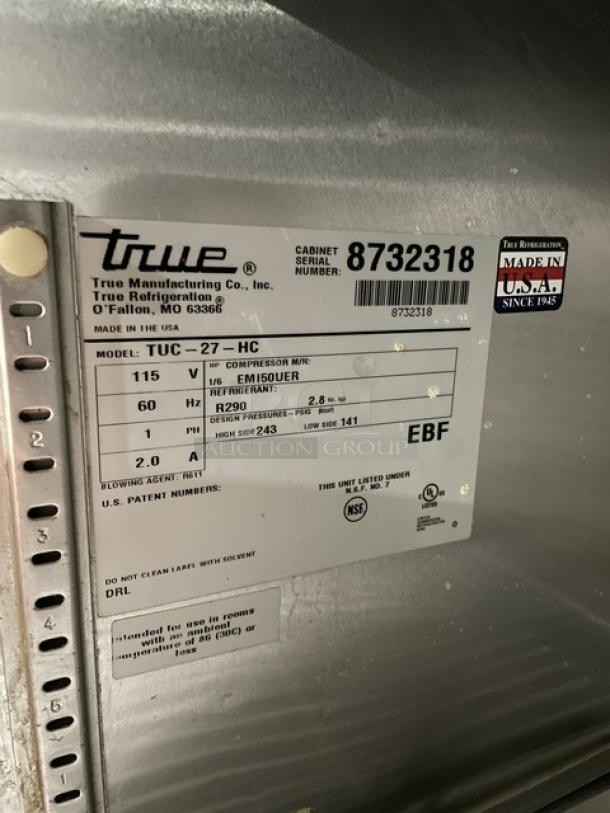 True TUC27HC lowboy cooler tag detailing model, serial 8732318, 115V, 1 phase, on casters. Made in USA.