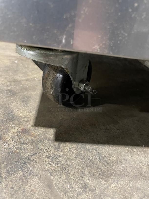 True TUC27HC stainless steel refrigerated lowboy cooler on casters, shown close-up of wheel, Model TUC27-C, Serial 8732318.