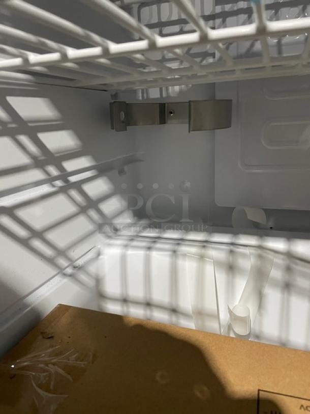 Edgestar BR3002BL kegerator interior, pristine condition, features shelving, metal fittings, and includes a beer keg.