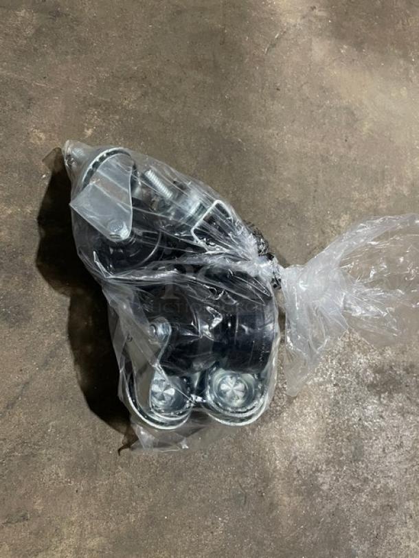 Plastic-wrapped set of casters on a concrete floor, part of an Edgestar BR3002BL kegerator.