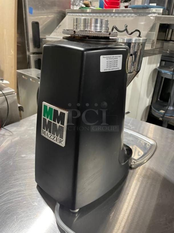 Mazzer Luigi Super Jolly espresso bean grinder, model Super Jolly, black, with visible Mazzer logo. Serial 1551890, 115V, 1 phase.