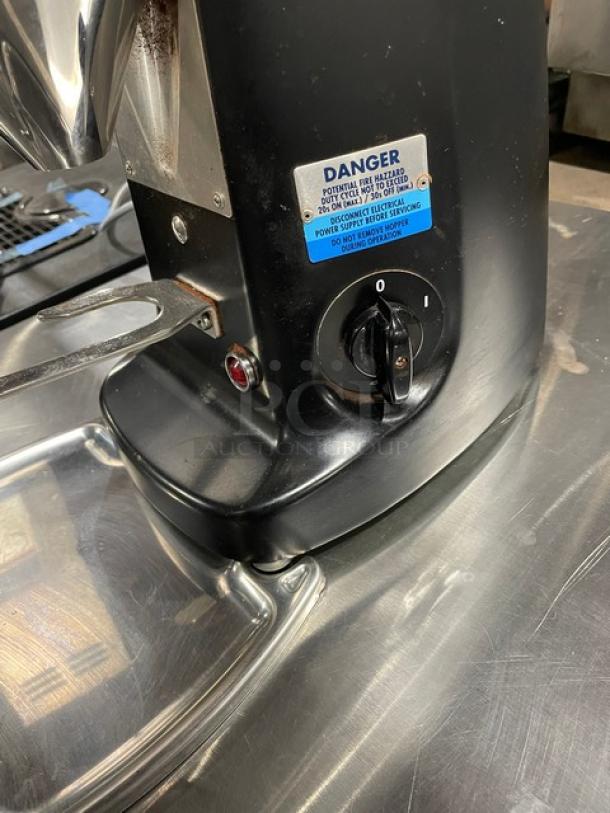 Mazzer Luigi Super Jolly espresso bean grinder, model 1551890, black countertop design with manual switch and safety label.