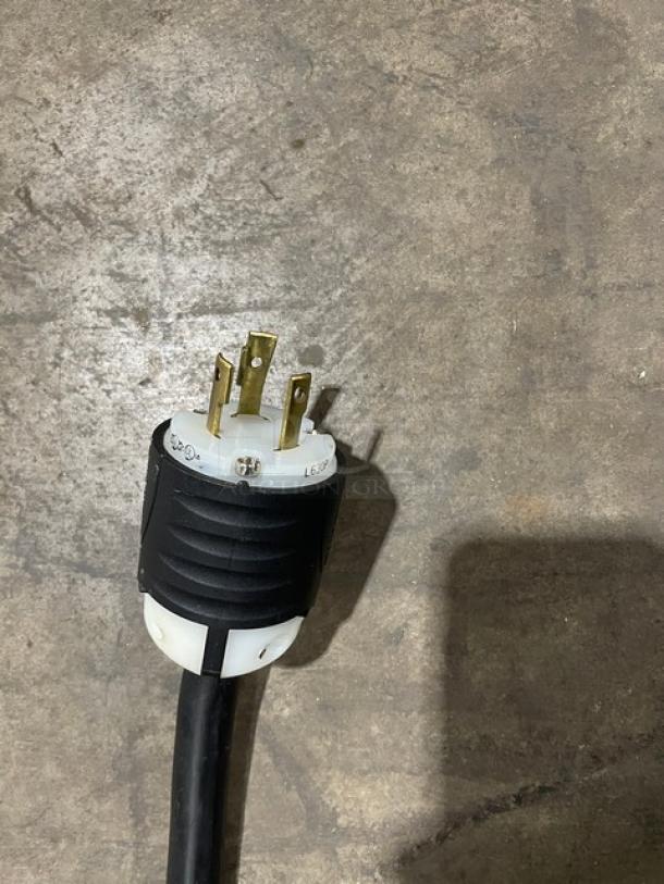 Bunn H5X electric hot water dispenser plug, 208V, 1 phase, showing a three-prong power connector on a concrete floor.