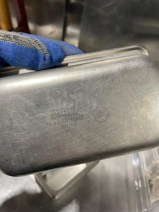 Stainless steel steam table pan by Amko, etched markings "Amko," "NSF," "Stainless Steel," "China," in good condition.
