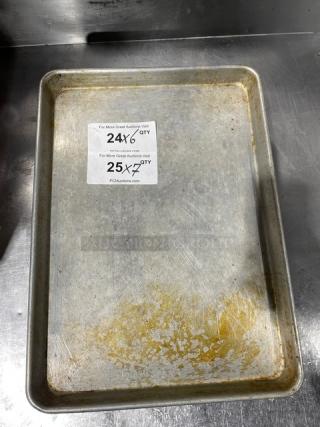 Commercial aluminum baking sheet pan, used, showing wear. Two auction labels visible with web address PCAuctions.com.