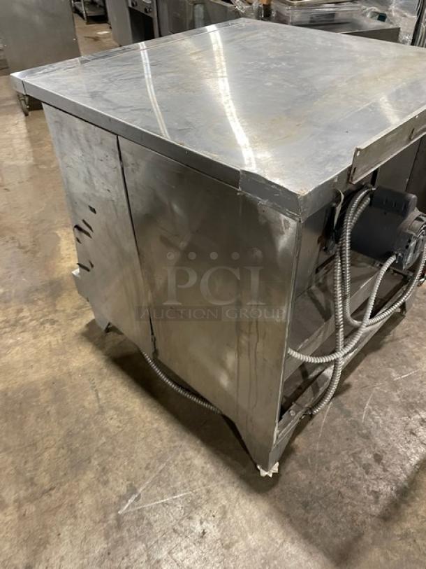 Garland Master Series commercial stainless steel gas-powered convection oven on legs, showing side and back, in used condition.