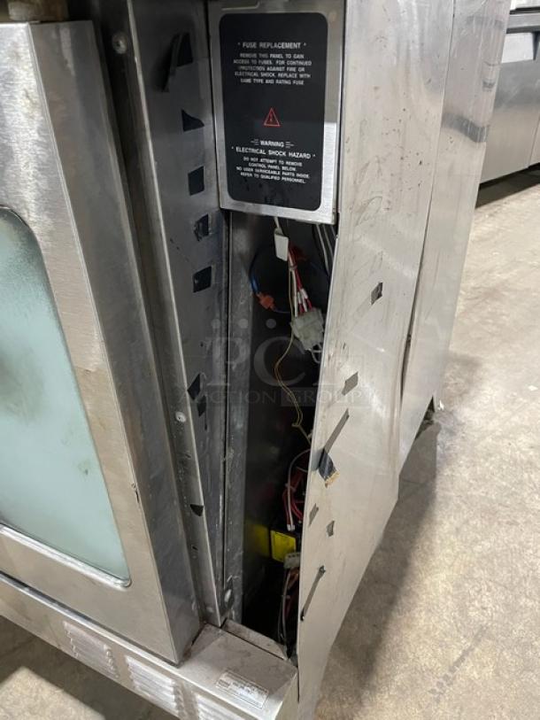 Garland Master Series single stack convection oven, stainless steel, gas-powered, on legs. Features internal wiring and a fuse replacement label.