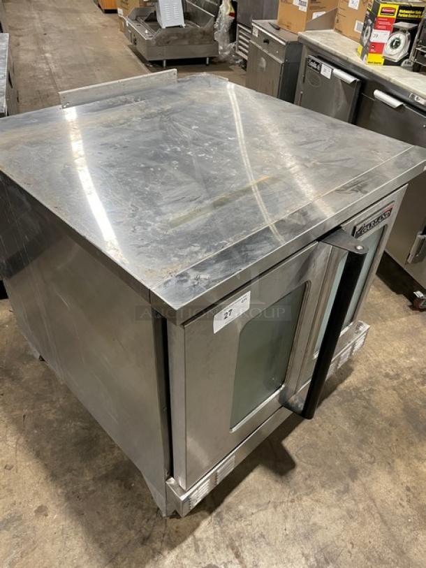 Garland Master Series stainless steel gas convection oven, single stack, on legs, visible wear, auction tag on door.