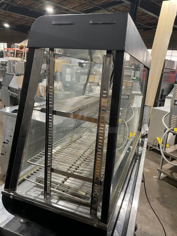 Adcraft 48" multi-tier glass heated display case with chrome-plated rack, rear sliding doors, 120V, excellent condition.