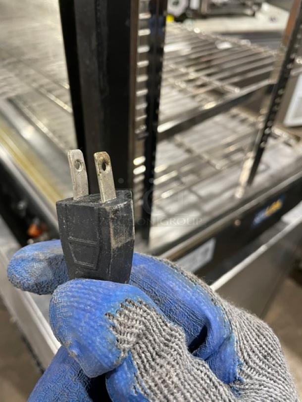 Adcraft commercial 48" heated display showcase with chrome rack, flat glass, and rear sliding doors; 120V power plug shown.