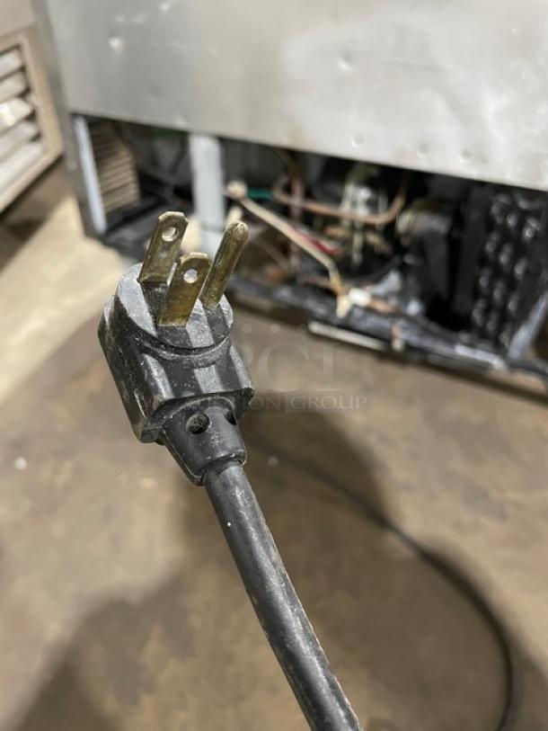 True Commercial Stainless Steel 2-Door Undercounter Refrigerator, Model TWT048, 115V, on casters, with visible plug.