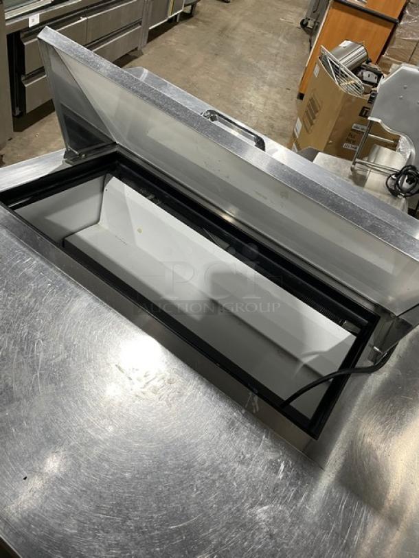 True TSSU-48-08 stainless steel 2-door undercounter refrigerator; includes worktop, model 4940880, 115V, on casters.