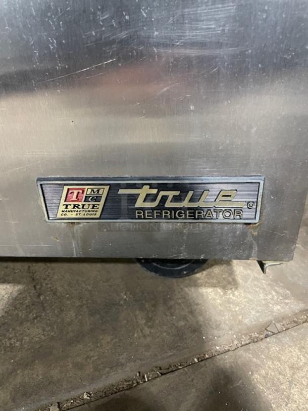 True TSSU-48-08 stainless steel 2-door undercounter refrigerator, commercial grade, model 4940880, on casters, visible logo.