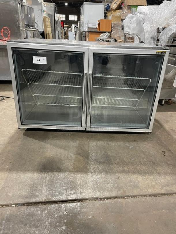 Silver King SK48G commercial stainless steel 2-door glass undercounter freezer with poly-coated wire rack in working condition.