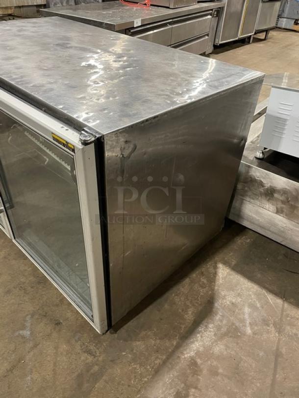 Silver King SK48G undercounter stainless steel freezer with dual glass doors and poly coated wired rack, in used condition.